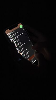 someone holding their cell phone in the dark