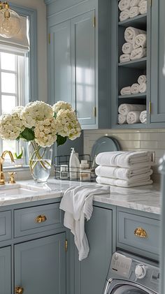 a washer and dryer in a room with blue cabinets