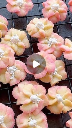 pink and yellow cookies with white frosting on a cooling rack