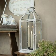 a white lantern sitting on top of a wooden table