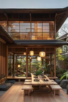 the inside of a house with wooden floors and tables in front of it, surrounded by plants