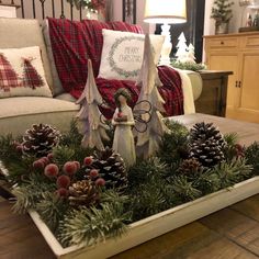 a tray filled with pine cones and christmas decorations