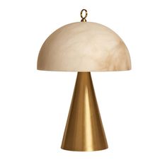 a brass table lamp with a white shade