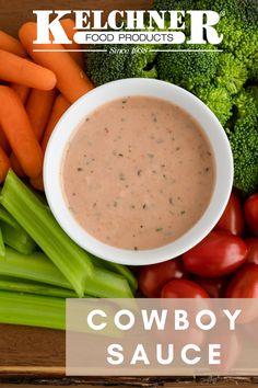 cowboy sauce in a bowl surrounded by carrots, celery and broccoli