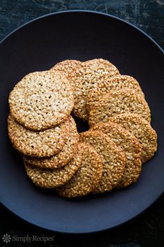 a black plate topped with cookies on top of a table