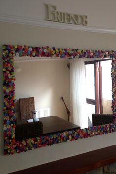 there is a mirror that has been made to look like flowers on the wall in this room