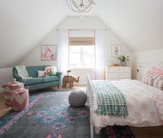 a bedroom with a bed, couch and rug in it