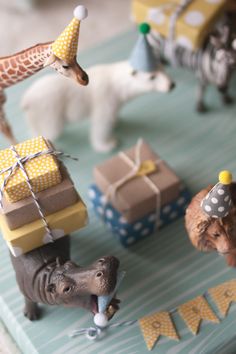 an instagram page with toy animals and presents on the table, including giraffes