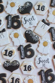 decorated cookies with black and white frosting are arranged in the shape of numbers, dates, and balloons