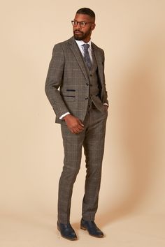 Spruce up in the Scott three piece suit. This vintage inspired suit draws inspiration from old age country tweeds featuring a subtle check laid upon a durable heavyweight fabric. Character is added with the navy velvet contrast pocket trims and an eye-catching blue paisley pocket square peeking through the top pocket. Model wears size 40R blazer, 40R waistcoat & 34R trousers. Features Slim fit Single-breasted Notch lapel Single back vent Four button cuff Double button blazer fastening Waistcoat Tweed Three-piece Suit With Notch Lapel For Work, Tailored Tweed Three-piece Suit, Tweed Three-piece Suit For Semi-formal Occasions, Semi-formal Tweed Three-piece Suit, Semi-formal Three-piece Tweed Suit, Tailored Plaid Tweed Jacket With Suit Collar, Tailored Tweed Three-piece Suit Single Breasted, Tailored Tweed Single-breasted Three-piece Suit, Fitted Tweed Three-piece Business Suit