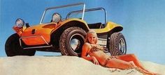 a woman laying in the sand next to an orange dune buggy