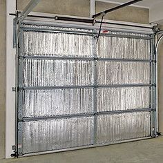 an overhead garage door is shown in the middle of a concrete flooring area with metal bars