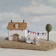 a small house on top of a piece of wood