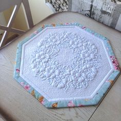 a table with a white doily sitting on top of it