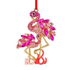 a pink flamingo ornament hanging from a red ribbon on a white background