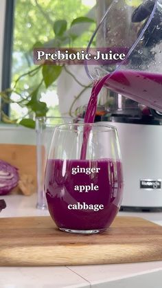 a glass filled with liquid sitting on top of a counter