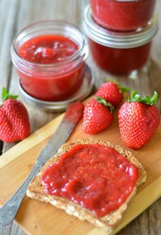 some strawberries and jam on a cutting board