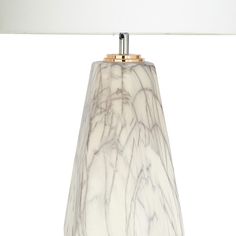 a marble lamp with a white shade on it