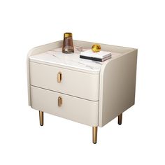 a white table with two drawers and a bottle on the top one drawer is gold