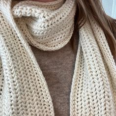 a close up of a person wearing a scarf