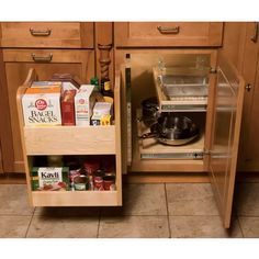 an open cabinet in the kitchen with food and condiments sitting on it's bottom shelf