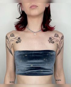 a woman with red hair and tattoos on her chest