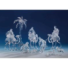 crystal figurines depicting the birth of jesus and three wise men on camels