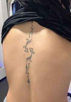 the back of a woman's lower back tattoo