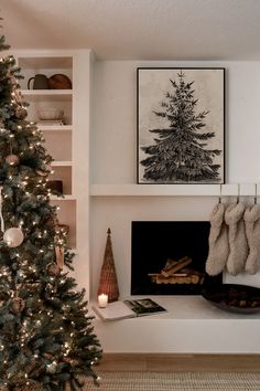 a decorated christmas tree in front of a fireplace