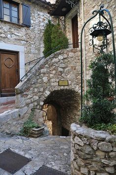 an old stone building with a door and steps leading up to the entry way that leads into it