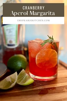 a close up of a drink on a table with limes