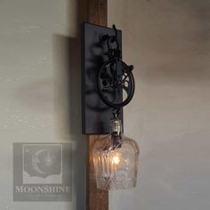 an old fashioned light fixture mounted on the side of a wall