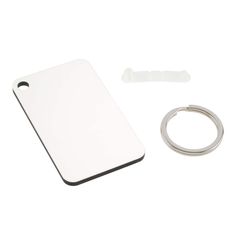 a white cutting board with a ring and an object next to it on a white background