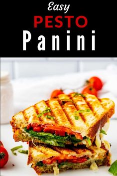 an easy pesto panini sandwich is cut in half on a white plate with tomatoes and basil