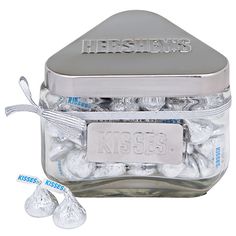 hershey's kisses in a glass jar with silver lid and white candy candies