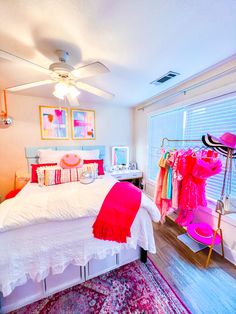 a bed room with a neatly made bed next to a window and a rug on the floor