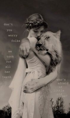 a woman hugging a wolf in front of a cloudy sky with the words, don't you worry folks we took out all her teeth