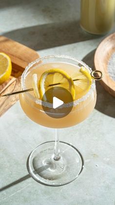 a glass filled with lemonade sitting on top of a table