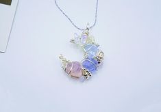 ･ﾟ✧ Why You'll Love It * Handcrafted with delicate wire-wrapping and soft pastel ombré natural gemstones (blue flash opal) and Czech glass (pink & purple glass stones) * 45 cm adjustable chain  * Ethereal crescent moon shape inspired by the magic of the night sky * Ideal for lovers of fairycore, princesscore, and celestial aesthetics * A unique gift for those who cherish romantic and fantasy-inspired jewelry ･ﾟ✧ A Celestial Dream in Pastels 🌙 Let your inner fairy queen shine with our soft paste Multicolor Wire Wrapped Crystal Necklace As Gift, Rainbow Wire Wrapped Round Jewelry, Iridescent Wire Wrapped Pendant Necklace, Iridescent Crystal Pendant For Jewelry Making, Iridescent Crystal Pendant Necklace For Jewelry Making, Bohemian Pastel Jewelry For Jewelry Making, Pastel Bohemian Jewelry For Jewelry Making, Bohemian Pastel Necklaces For Gifts, Bohemian Pastel Necklaces Gift