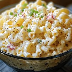 a bowl filled with macaroni and cheese on top of a table