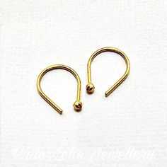 "Solid 24k gold earrings. Ball earrings. Minimalist earrings. 24k gold Huggies. Hand forged solid 24k gold. Hypo allergenic earrings. Read description These are solid 24k gold earrings. I hand forge them in my studio and they are shipped with rubber guards. Ball nugget is approx. 2 mm and length of earring 1/2\" (13 mm). Tiny earrings. As with any handmade or forged jewelry, the earrings will have a nugget ball end (not perfectly round or smooth) and the post is forged (not smooth). Also availab Gold Recycled Gold Huggie Earrings Gift, Small Hoop Gold Cartilage Earrings As Gift, Minimalist Gold Cartilage Earrings With Ear Wire, Minimalist Gold Huggie Earrings As Gift, Minimalist Yellow Gold Cartilage Earrings For Gift, Minimalist Yellow Gold Cartilage Earrings As Gift, Minimalist Yellow Gold Cartilage Earrings, Gold Hammered Huggie Earrings, Adjustable Yellow Gold Cartilage Earrings With Ear Wire