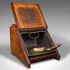 an old wooden box with a knife in it's opening and the lid open