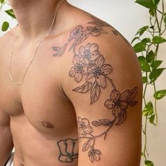 a shirtless man with flowers on his chest