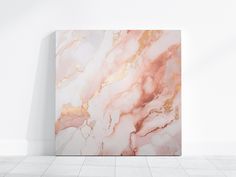 an abstract painting in pink and gold on a white wall next to a tiled floor