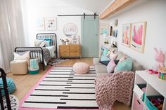 a living room filled with lots of furniture and pictures on the wall next to a bed