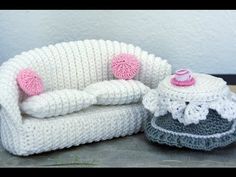 two crocheted chairs and a footstool are sitting next to each other