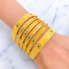 Elevate your style with our Vibrant Festive Floral 22K Gold Bangle Set. Crafted in 22k gold, this exquisite set features a total weight of 109.2g, radiating opulence. Adorned with stunning Kundan stones, the yellow gold finish adds a touch of high fashion. Bangle Size 2.6 with a 2.35" diameter opening. Set includes 6 captivating bangles. PRODUCT DETAILS Gold Purity(karat): 22k Item Weight(grams): 109.2 Item Finish: Yellow Gold Stone: Kundan Bangle Size: 2.6 Bangle Opening(diameter): 2.35" Number Hand Set 22k Gold Festive Bracelets, Hand-set Yellow Gold Bracelets For Diwali, 22k Gold Hand Set Festive Bracelets, Hand Set 22k Gold Bangle, Hand Set Yellow Gold Bracelet For Diwali, 22k Gold Bangle For Festive Occasions, Festive 22k Gold Hand-set Bangle, 22k Gold Meenakari Bangle In Yellow Gold, Luxury Gold Bangle For Festive Season