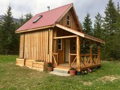 a small wooden cabin with a red roof