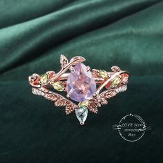 Art Deco Pear Lavender Amethyst engagement ring Bridal Set Rose Gold Unique Leaf Nature Inspired  Gemstone Promise Cluster ring jewelry Gift (Please comfirm your US size when you make an order) Jewelry details: Matal Type: 14k gold /18k gold Engagement Ring: Center Stone: Lavender Amethyst Stone Size: 6*8mm Side stones: peridot Total weight: 0.18ctw (High Quality) Wedding band Moss Agate and moissanite Carat Weight: approx. 0.182ctw Or: black sapphire (If you choose side stone in black sapphire) Purchase Guarantee: 1: Provide you with the best service. 2: 14 Day Refund Guarantee. 3: Free Gift Box&Packing 4: Free Shipping and insurance to All Parts Of The World. Accessories: beautiful Ring box, and little gifts. Processing time: When we receive payment We need 2-3 weeks to work for your ite Exquisite Amethyst Wedding Ring With Gemstone Accents, Exquisite Amethyst Ring For Wedding, Purple Rose Cut Diamond Jewelry For Wedding, Purple Amethyst Ring With Rose Cut Diamonds For Wedding, Rose Gold Amethyst Ring With Gemstone Accents For Wedding, Rose Cut Amethyst Jewelry For Wedding, Wedding Amethyst Multi-stone Crystal Ring, Pink Amethyst Ring With Gemstone Accents For Wedding, Fine Jewelry Amethyst Ring With Gemstone Accents For Wedding