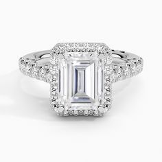 an emerald cut engagement ring with diamond halos